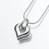 Silver heart-shaped necklace with a small gemstone charm on a silver chain.