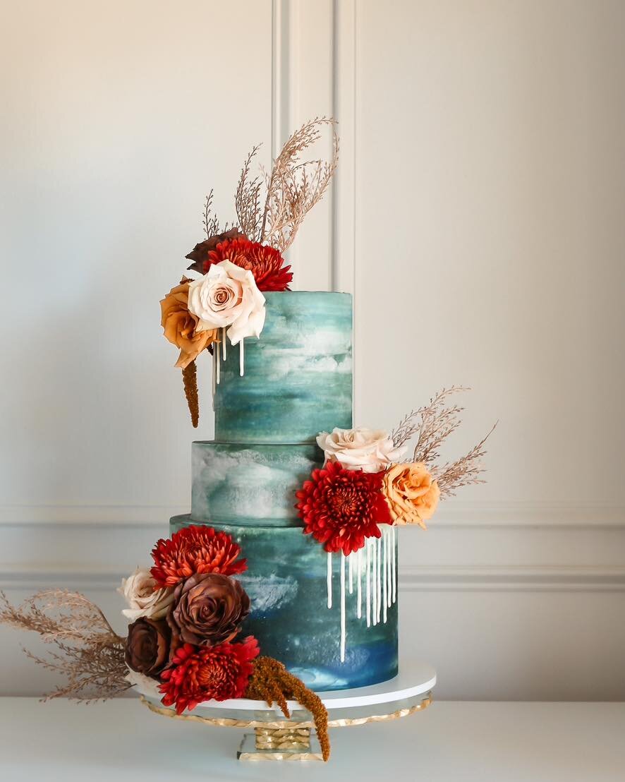 Ever green (and teal). 

Emerald green tones tossed in waves of teal and white make this cake look (and sound) like the ocean. Florals in red, orange, and pink bring a much needed pop of color and hint of earthiness. 

Head on over to my website to r