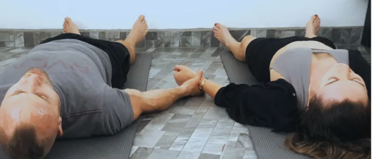 Couples relaxing during a gentle yoga practice at a Loopwell couples retreat in the Hudson Valley