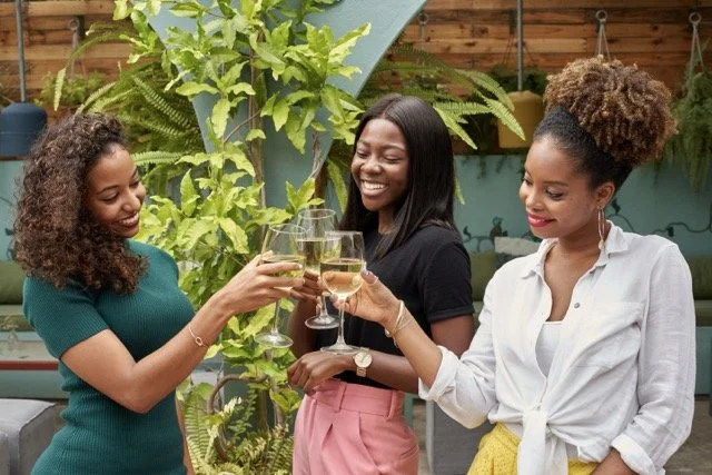 three-young-women-toasting-with-drinks-outdoors-2026-01-05-00-57-23-utc Medium.jpeg