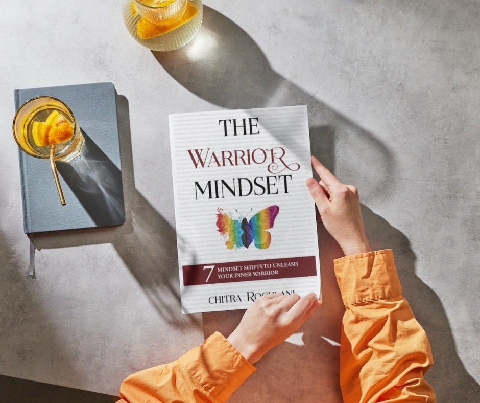 A book on a table titled The Warrior Mindset by Chitra Rochlani