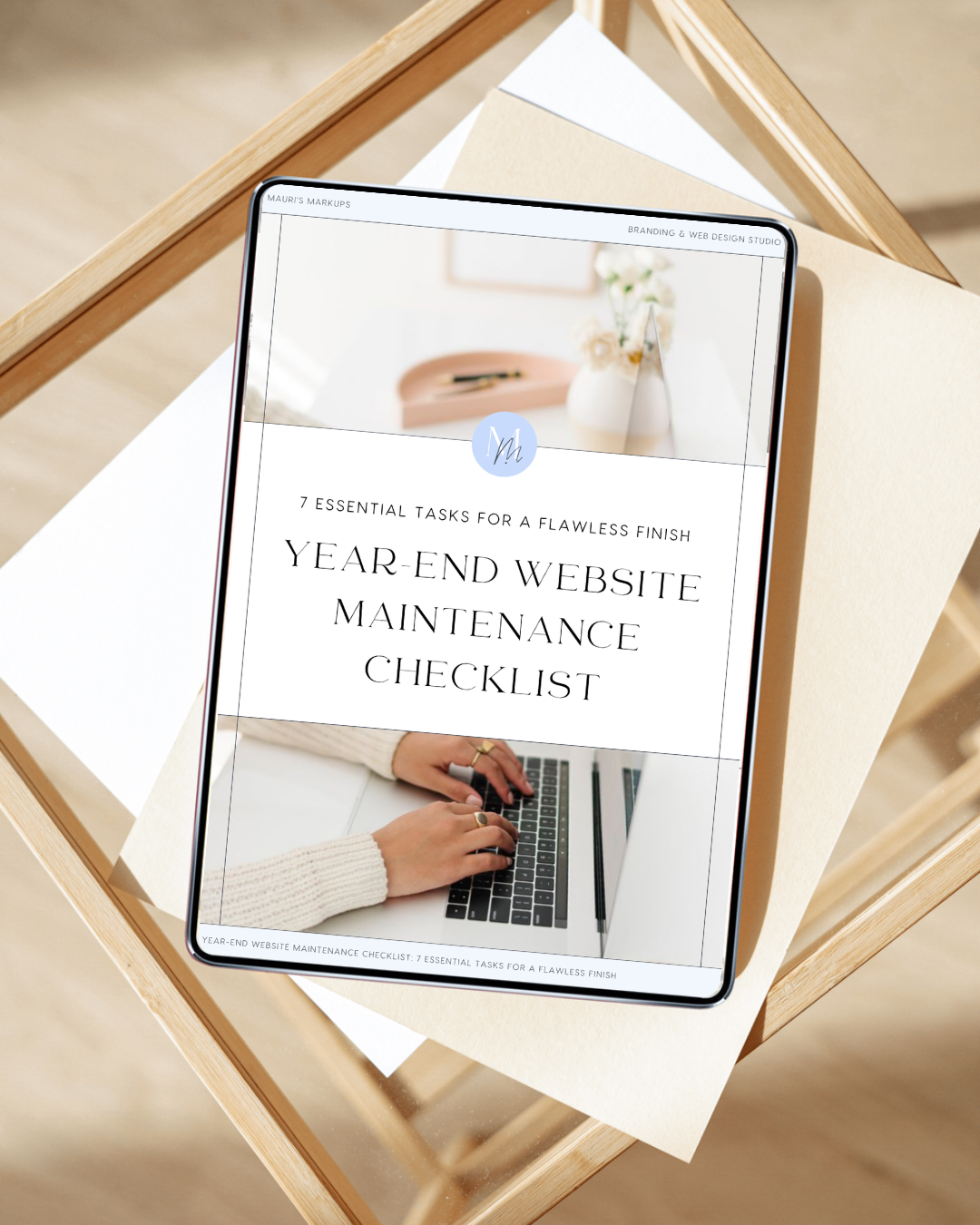 iPad displaying a website titled 'Year-End Website Maintenance Checklist' with a background of a person typing on a laptop and decorative vases and flowers in the background.