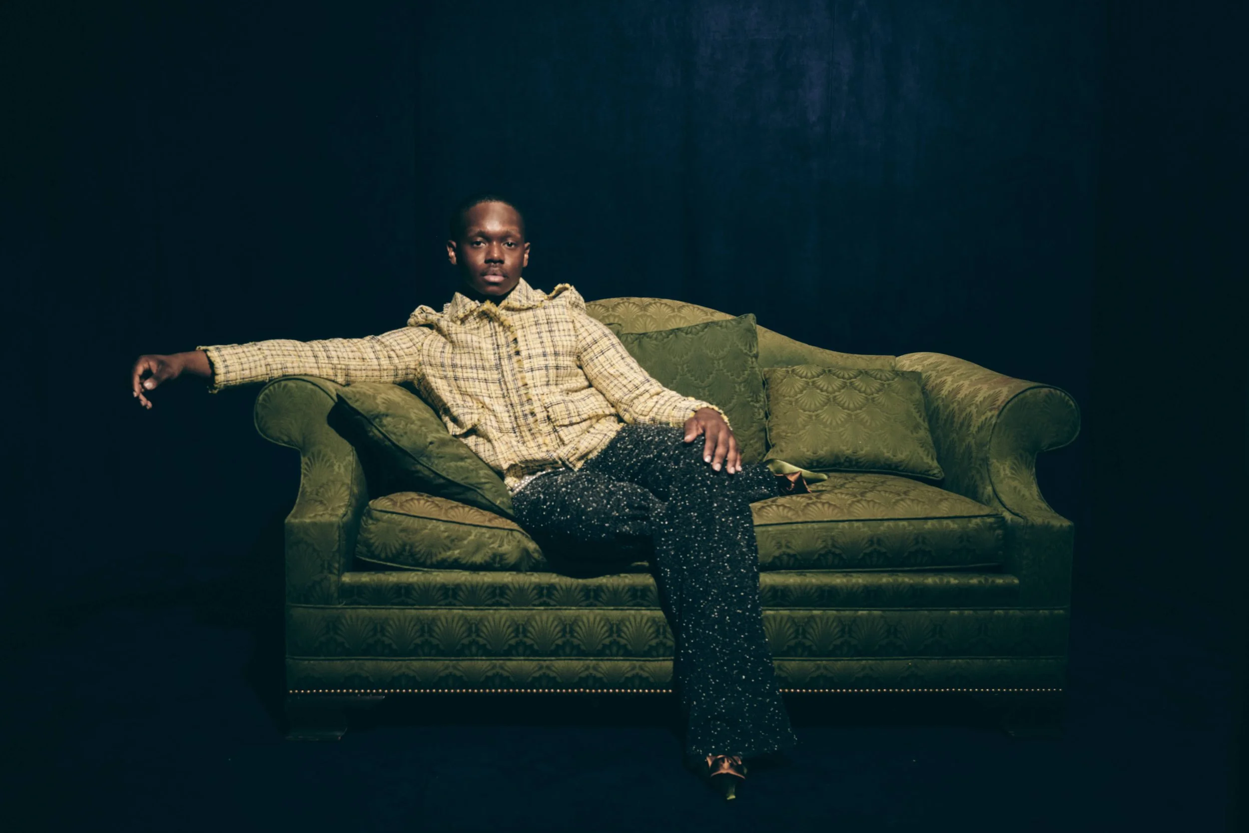 Portrait of a man seated on a green couch