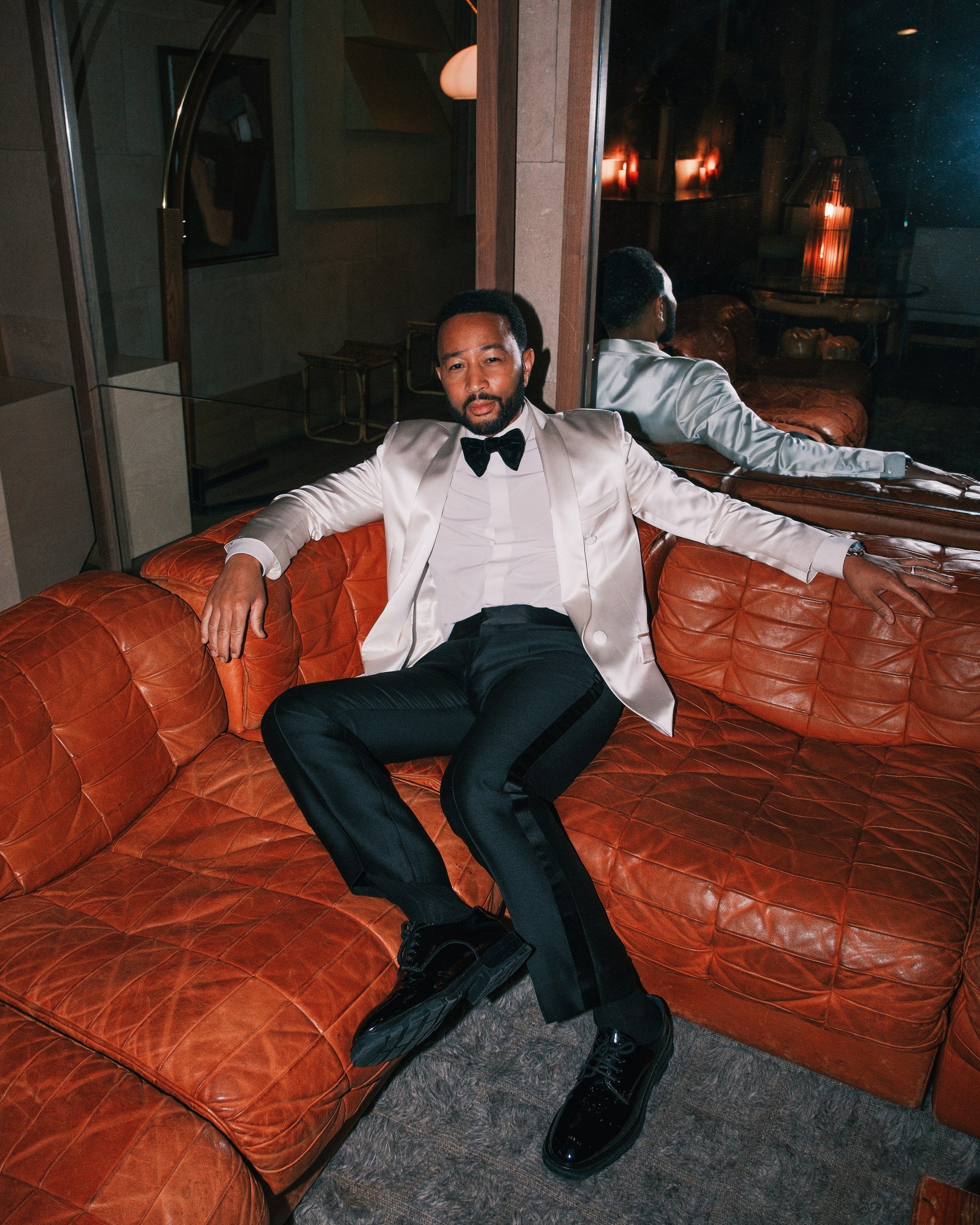 John Legend on a leather sofa at the Santa Monica Proper Hotel