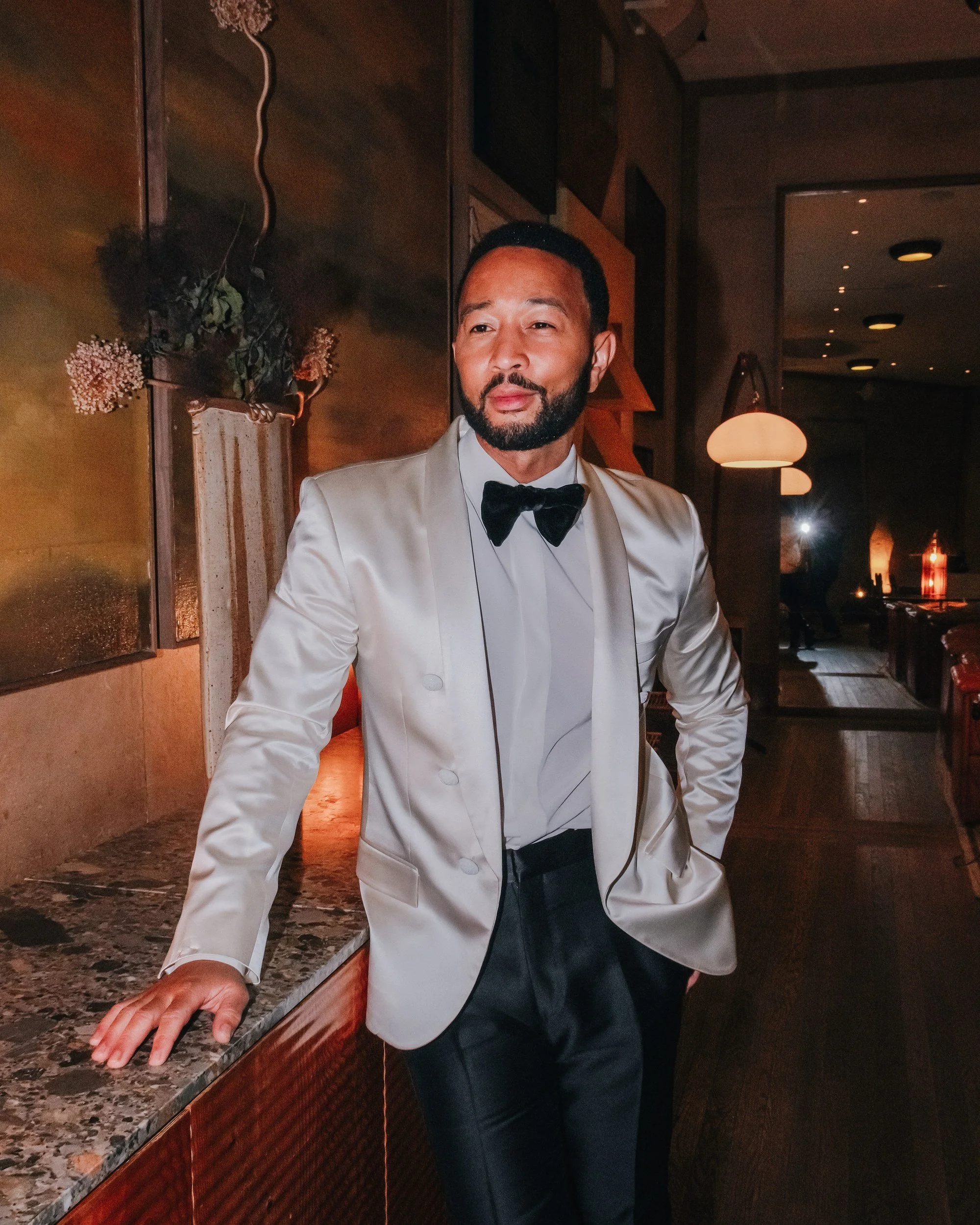 Portrait of John Legend in a white dinner jacket at Santa Monica Proper