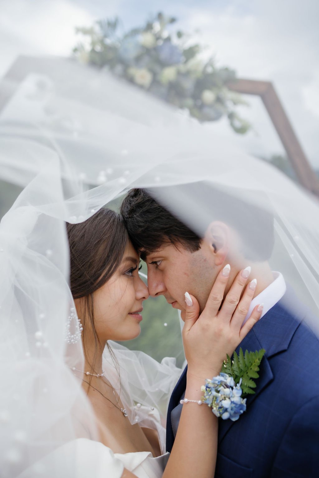 gatlinburg-photographer-mountain-mist-farms-wedding-venue-bride-groom-under-veil
