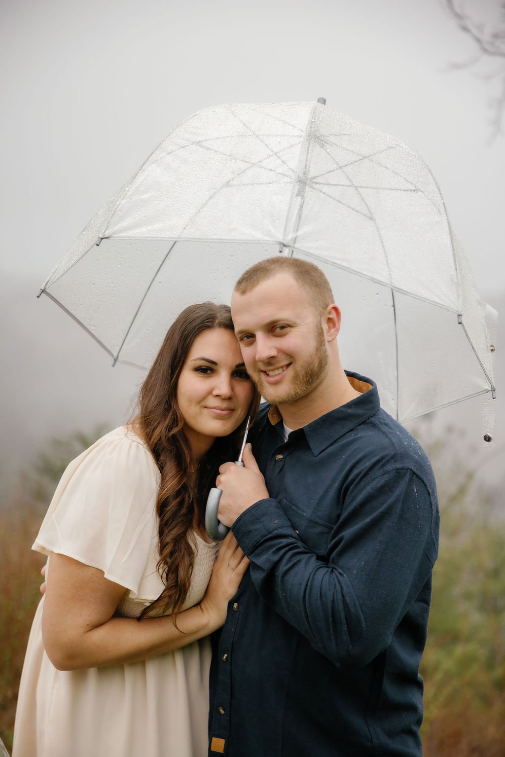 gatlinburg-family-photographer-tips-for-family-photos-with-a-toddler-couple-holding-clear-umbrella