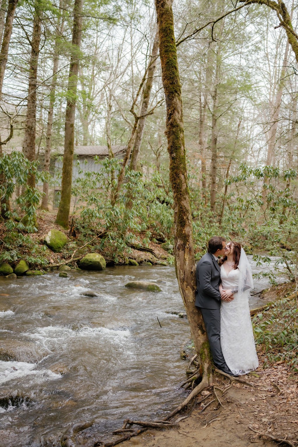 gatlinburg-photographer-waterfall-elopement-in-the-smoky-mountains-couple-embracing-by-water