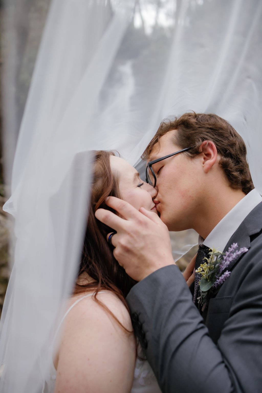 gatlinburg-photographer-waterfall-elopement-in-the-smoky-mountains-bride-groom-kissing-under-veil