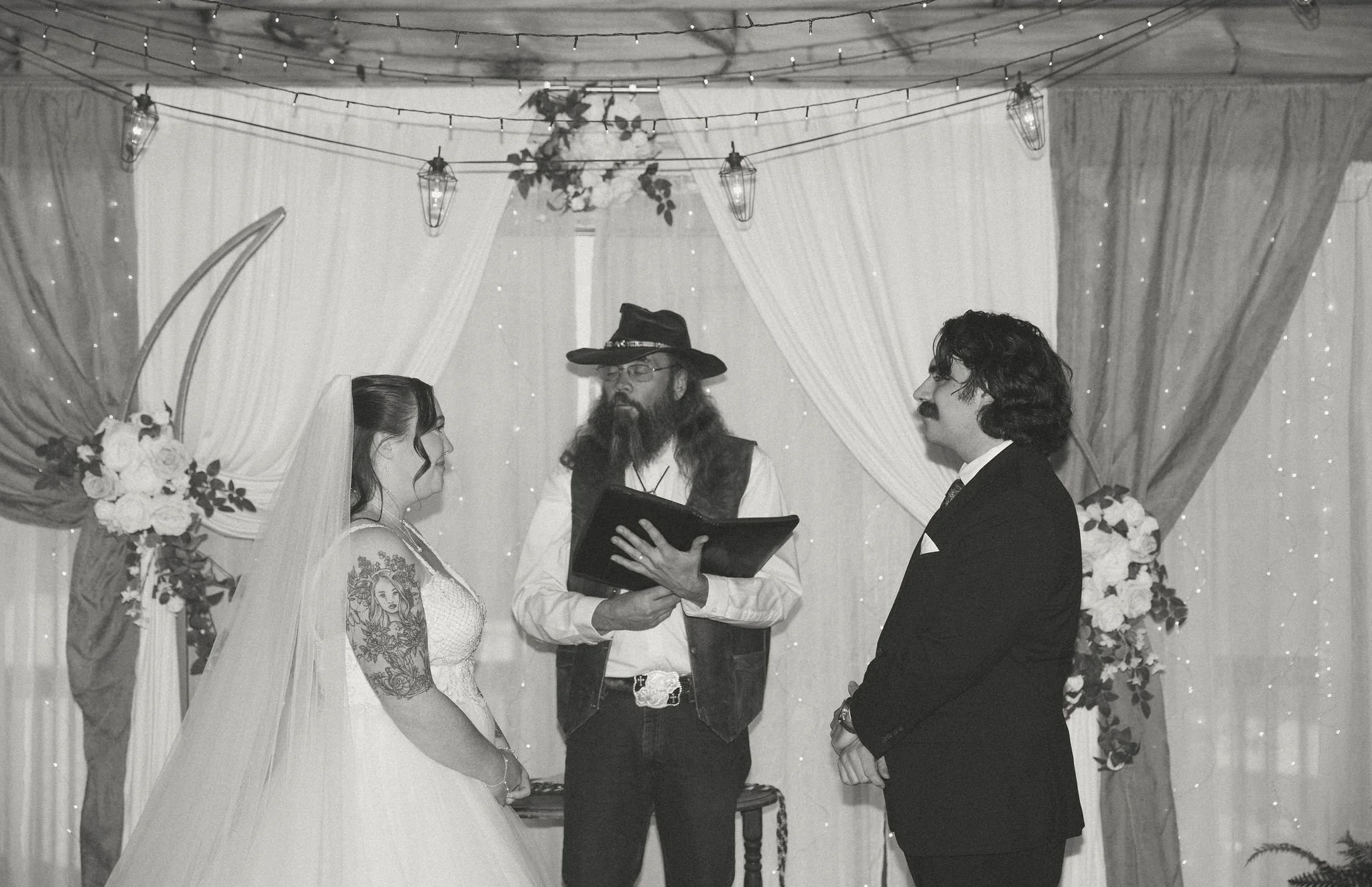 Bride and groom exchanging vows during a cozy indoor micro wedding ceremony officiated in a rustic Smoky Mountain venue, captured by a Gatlinburg elopement photographer.
