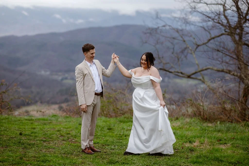 gatlinburg photographer captures wedding photo of bride and groom dancing together on the foothills parkways on an outlook