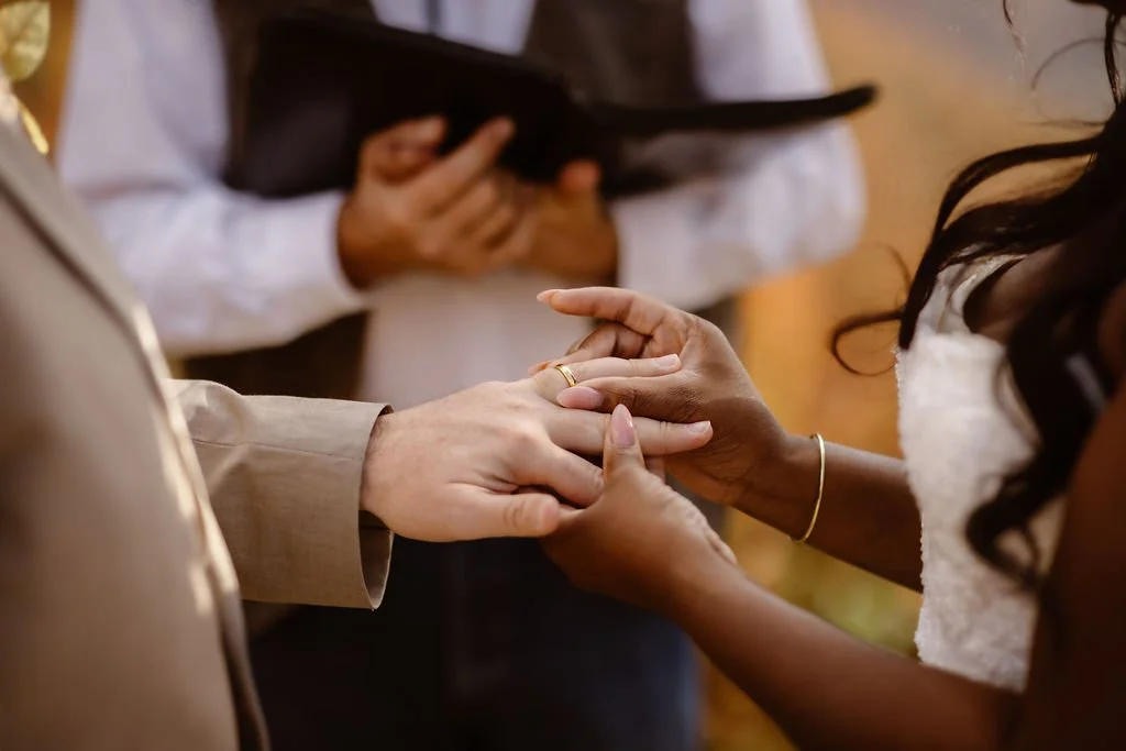 Close-up of bride placing wedding ring on groom’s hand during ceremony, foothills parkway elopement photography capturing intimate Smoky Mountains fall wedding detail by a gatlinburg photographer specializing in outdoor elopements