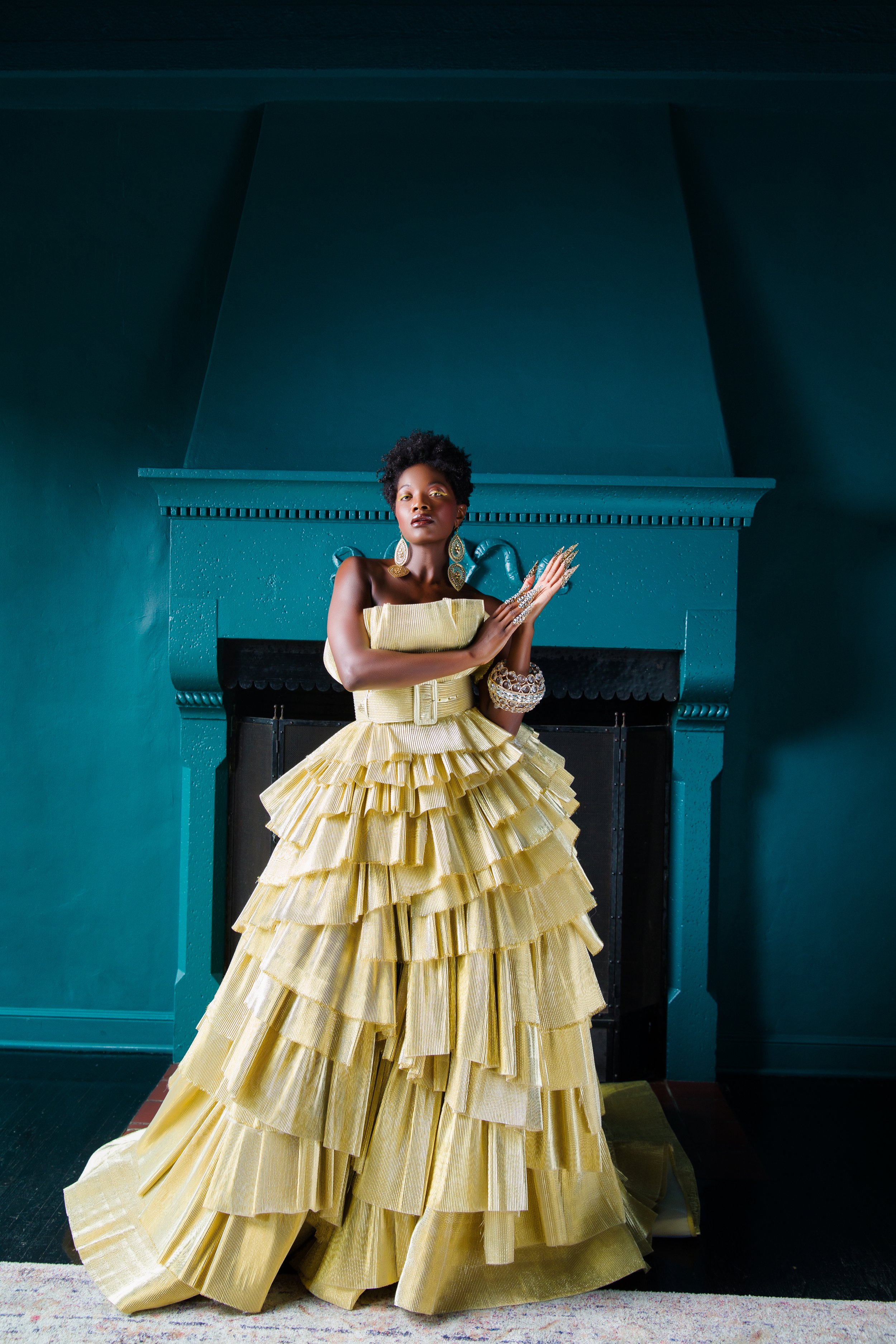  The Accordion Pleaded Layered Gold Ball Gown, was designed a couple years ago when Arminé got her hands on the gorgeous&nbsp;gold accordion pleated lame fabric. It was then where she finally knew that her sketch&nbsp;that was sitting in her sketchbo
