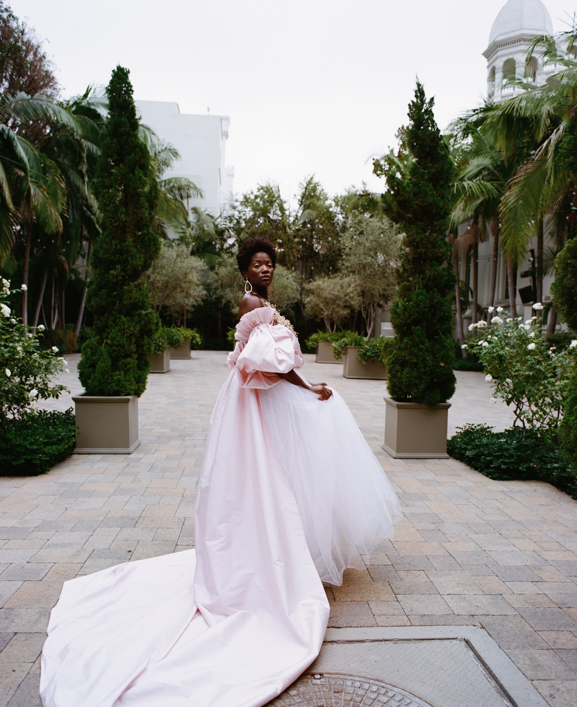  The off the shoulder Silk Taffeta Pink Long Cape with pleated detailed&nbsp;big sleeves is draped over the pink and white tulle skirt. This look is&nbsp;finished&nbsp;with crystal hoop earrings and a beautiful&nbsp;hand-made crystal and gold huge ne