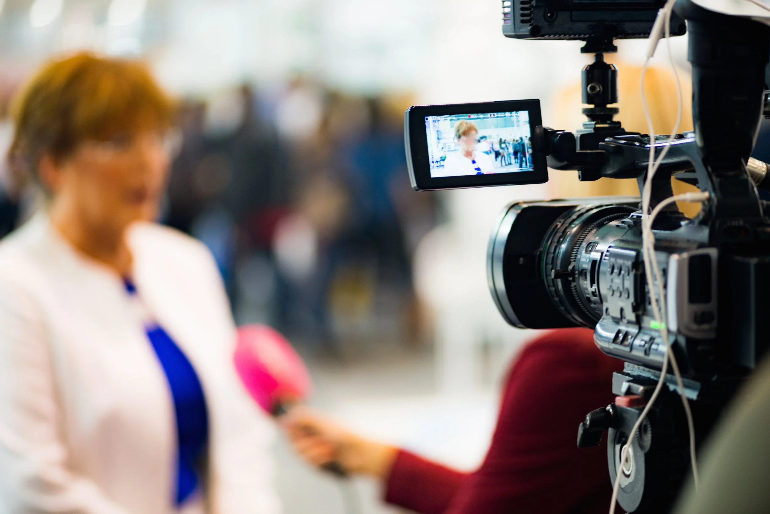 Behind-the-scenes view of a VAMP Media videographer filming a corporate video production session in Pittsburgh.