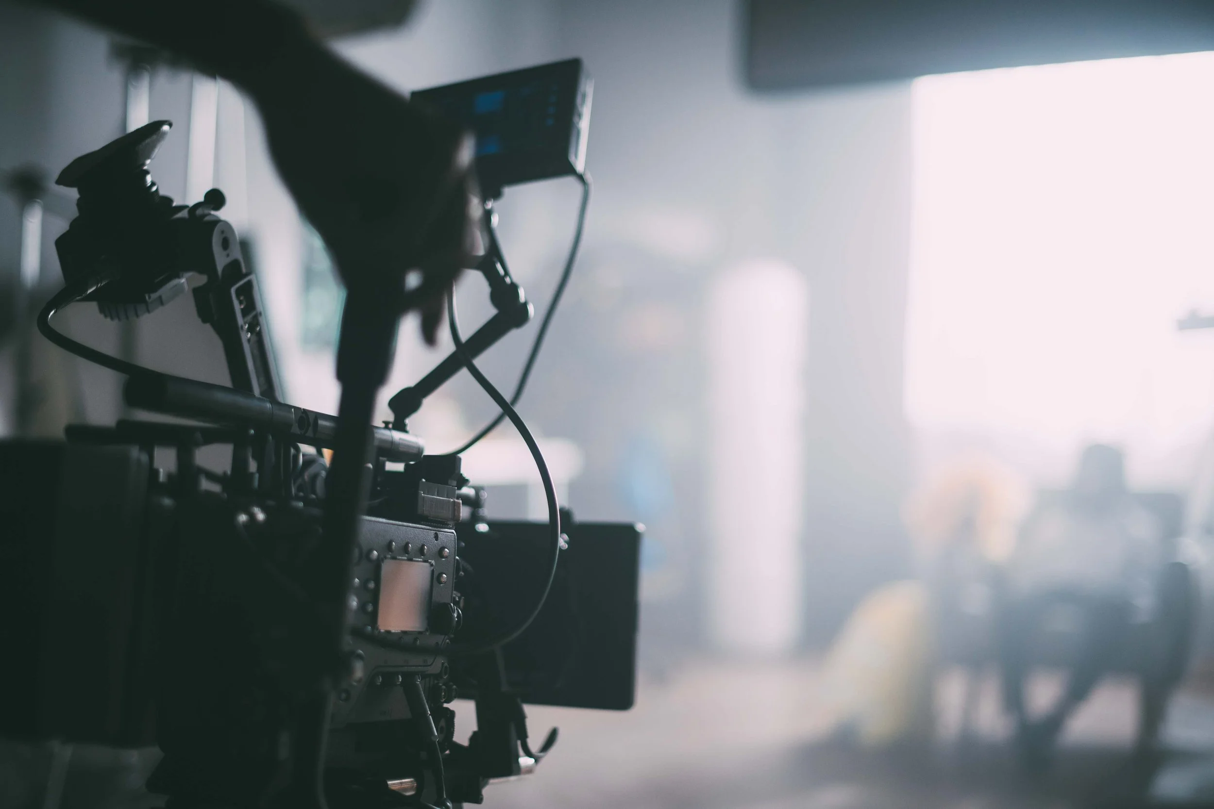 Professional multi-camera video production crew filming a high-end corporate media project on location.