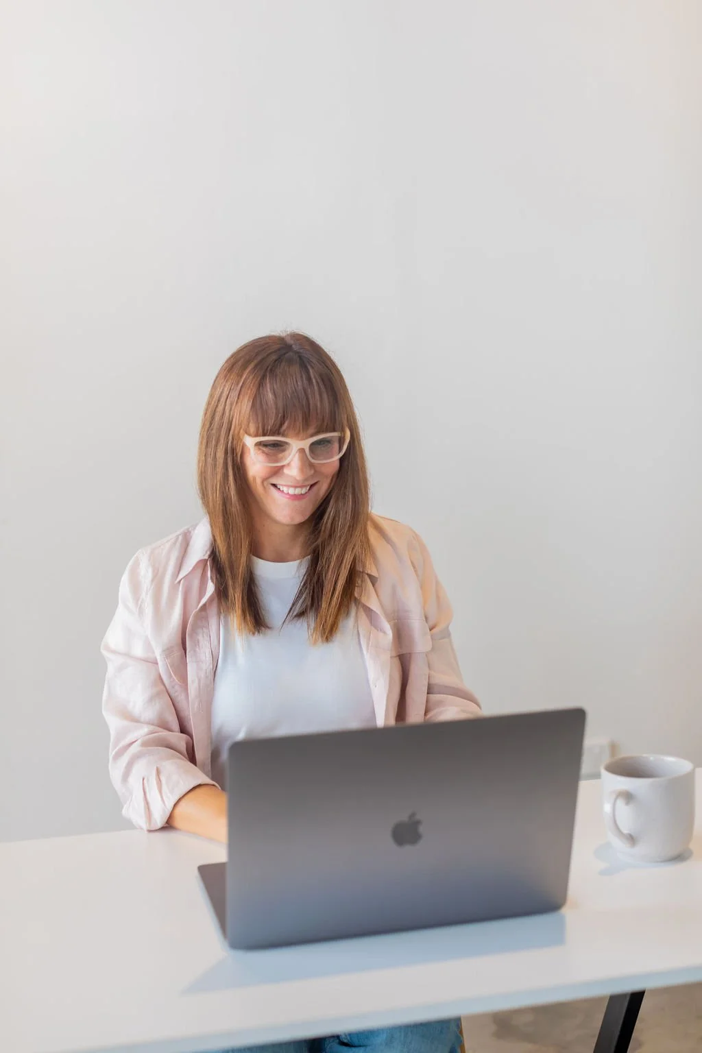 Ina sitting typing on her laptop