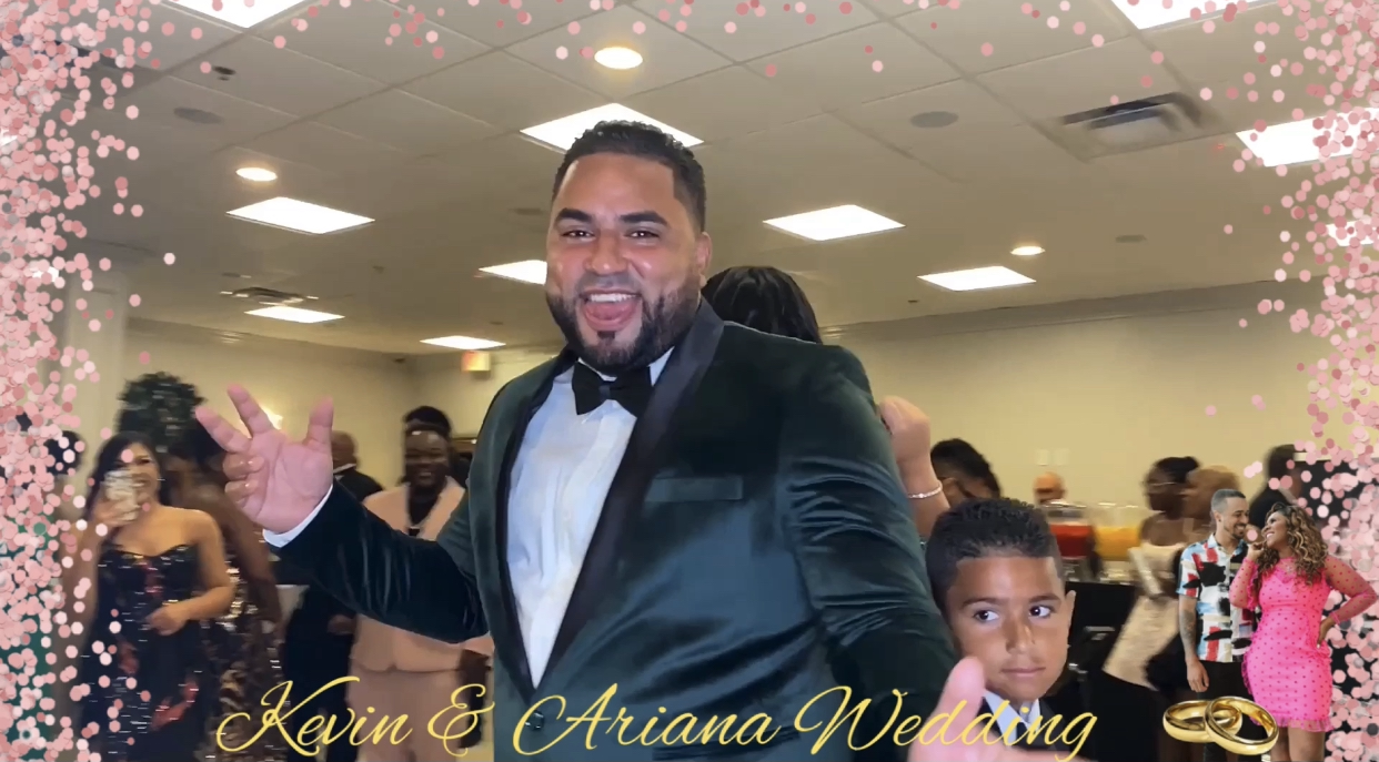 A man in a tuxedo and a boy in a black outfit pose at a wedding celebration, with guests in formal attire in the background and floral and ring graphics on the frame, text reading 'Kevin & Ariana Wedding.'