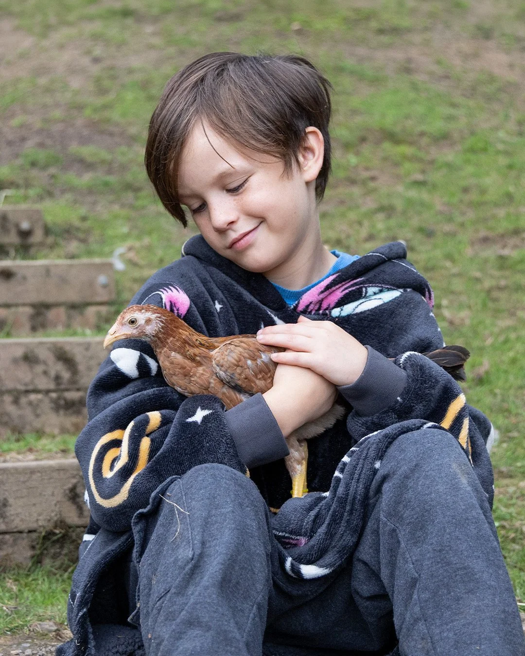 Roman holding Chickpea, a rescued bird, at Wildlings Forest.