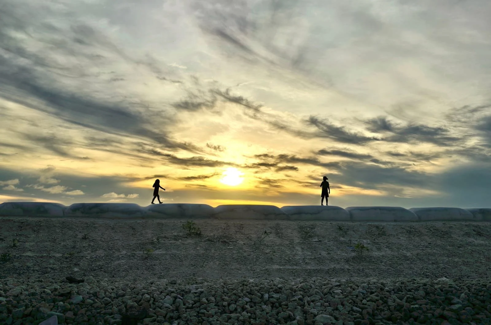 Tuvaluan children walking over seawall