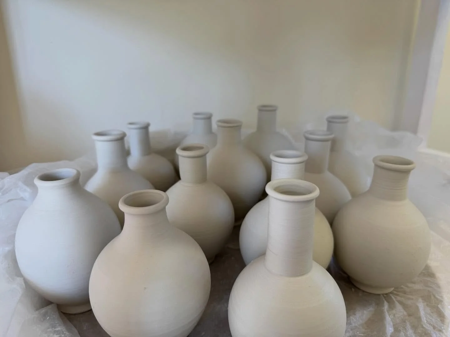 Small vases, unfired, are the most enticing to paint, and very good at filling up small spaces in the kiln.

#tinyvases
#smallflowers