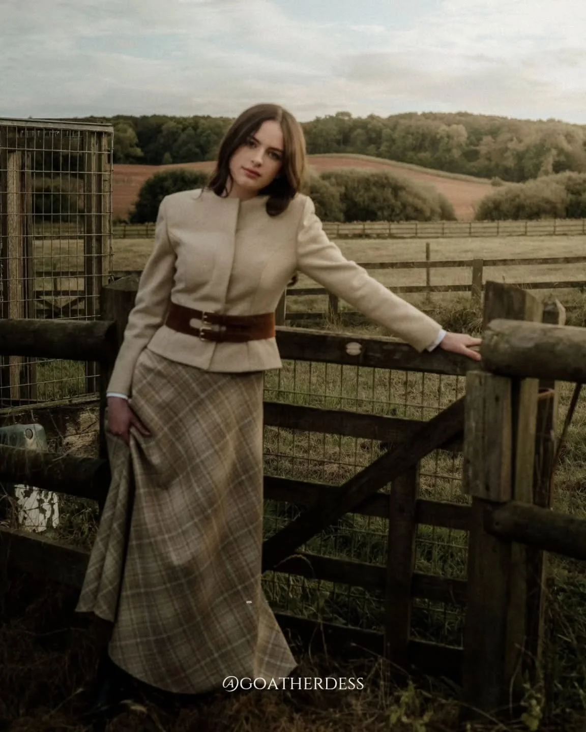 The Jane jacket, Elizabeth skirt, and handmade belt capture timeless countryside elegance. Crafted from rare breed wool, each piece blends heritage with modern tailoring. Designed to flatter, endure, and be cherished, this look embodies Goatherdess&r