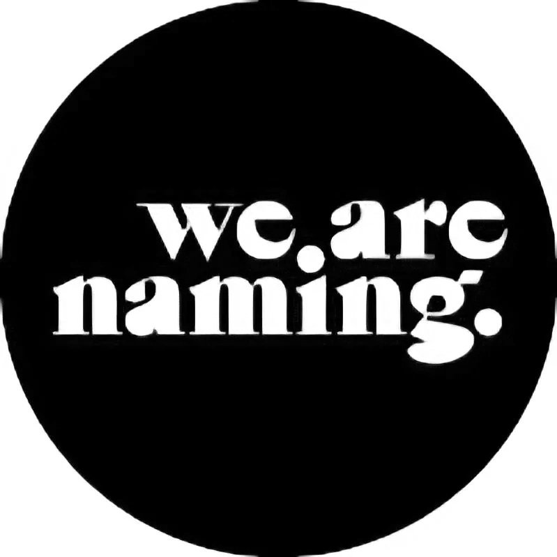 Black circular sign with white text that reads 'wc are haming.'