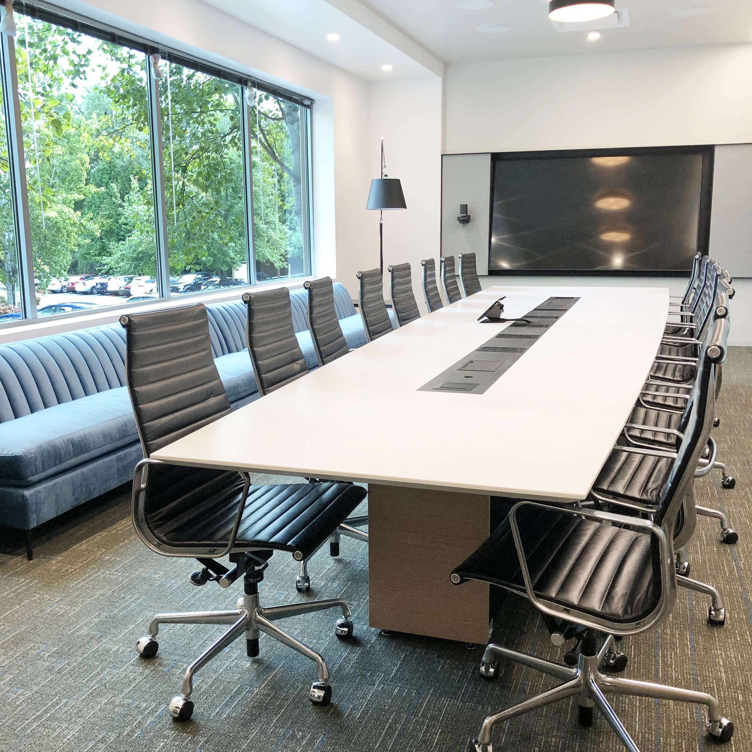 CUSTOM CONFERENCE TABLE WITH SOLID SURFACE TOP WITH CUSTOM STEEL + DATA INLAY