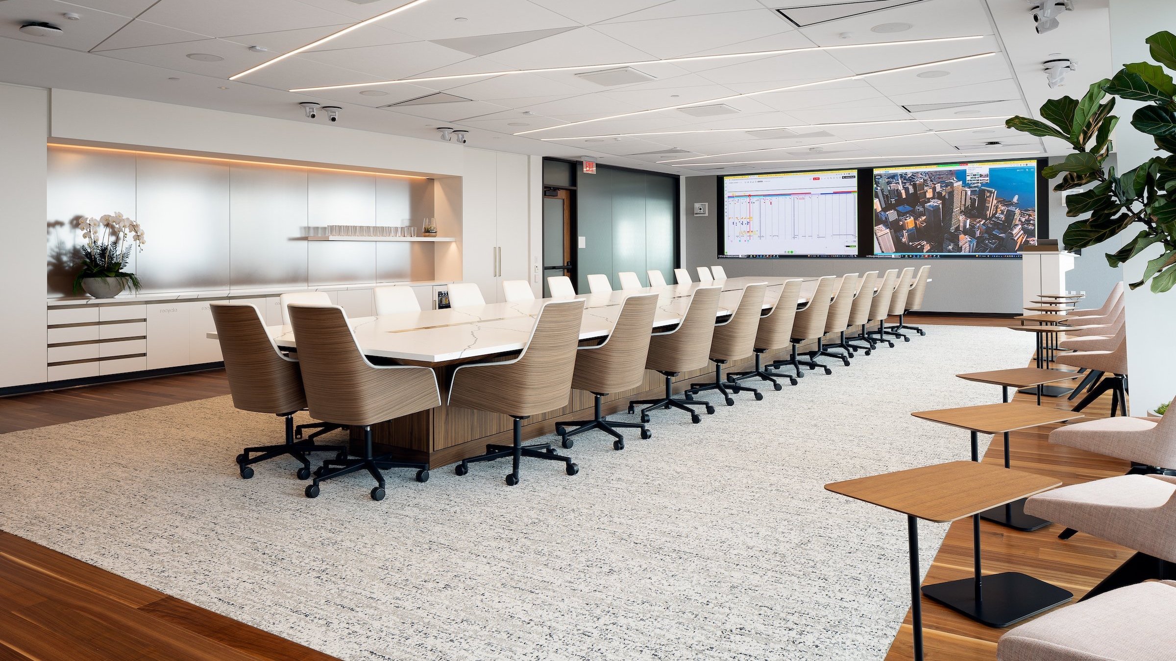 THE 28 PERSON BOARDROOM TABLE IS OVER 35 FEET LONG WITH A TRAPEZOID SHAPED TOP THAT IS 72" WIDE AT THE NARROW END AND 120" WIDE AT THE WIDER END