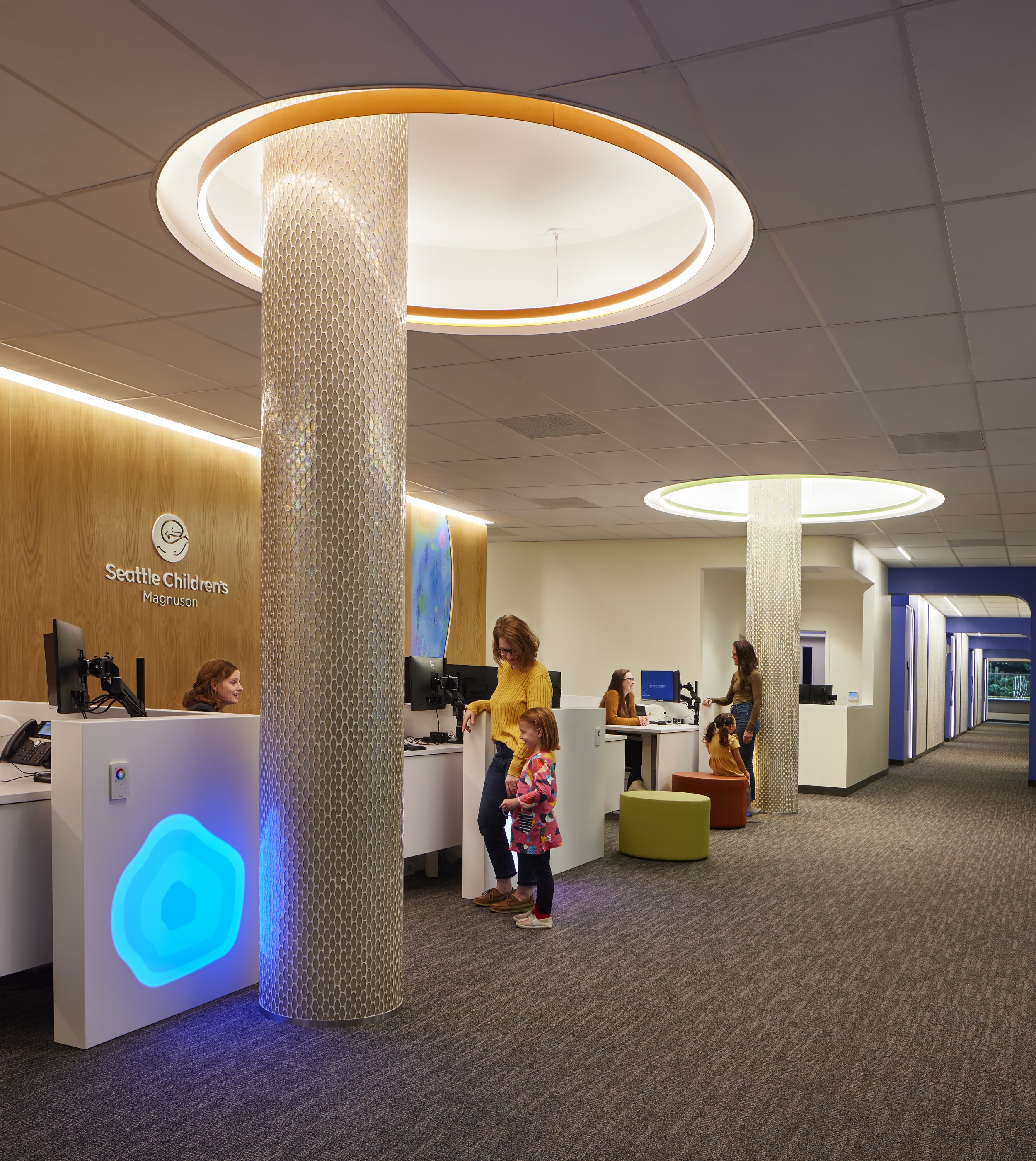 SOLD SURFACE RECEPTION DESKS WITH LED LIGHT UP PODS CONTROLLED BY CHILDREN DURING CHECK IN/OUT FOR SEATTLE CHILDREN'S