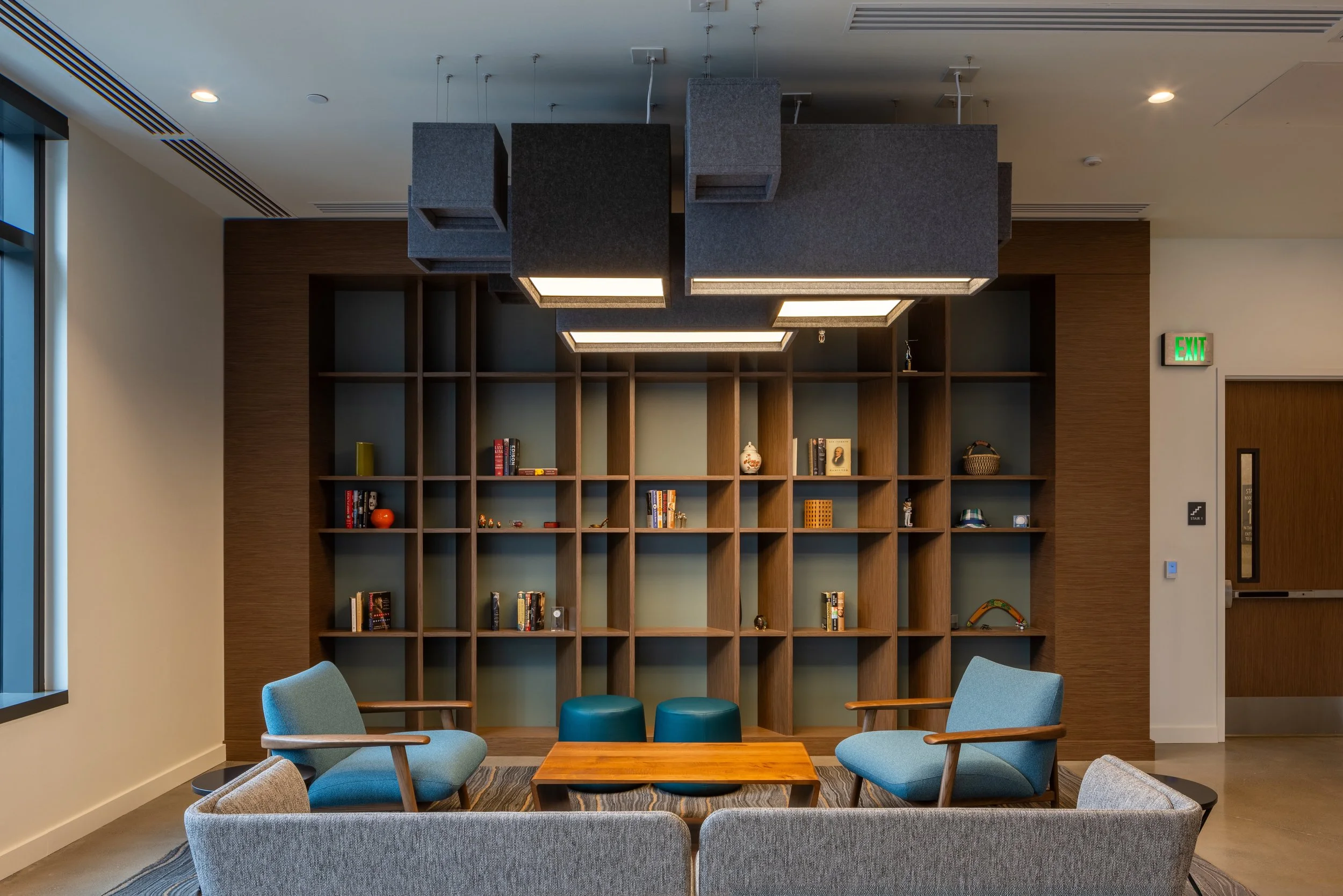 CUSTOM ANGLED BOOKCASE IN WALNUT VENEER WITH NATURAL FINISH
