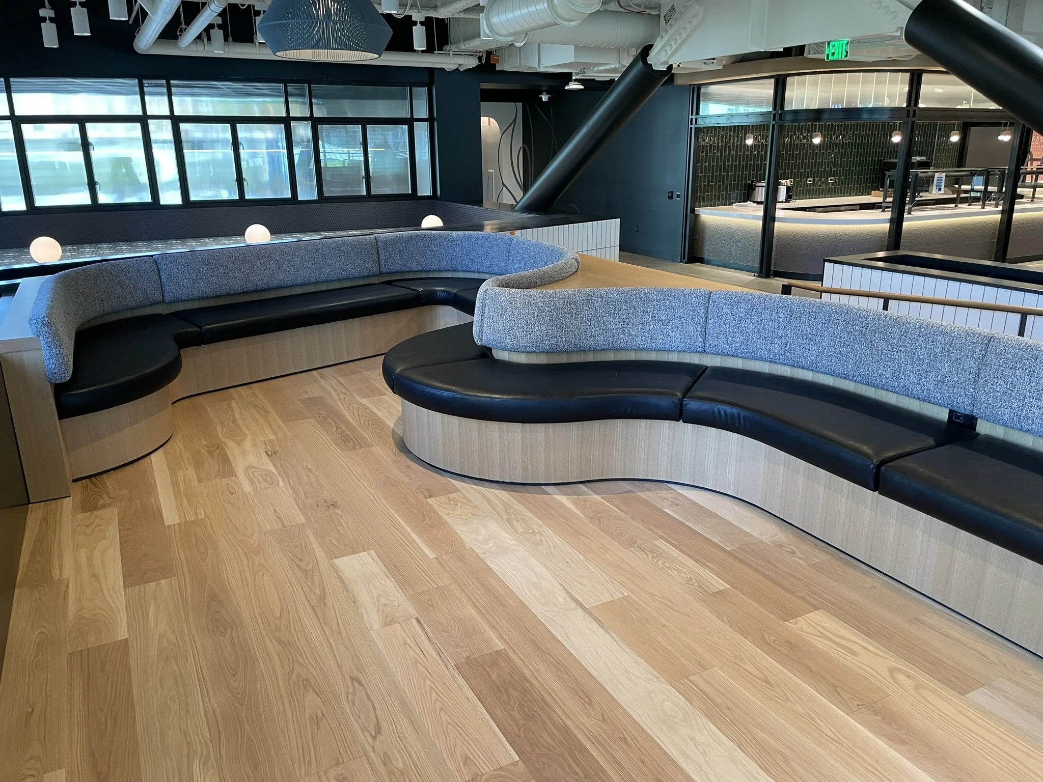 CUSTOM CURVED SHAPE BANQUETTE WITH WHITE OAK VENEER BOX BASE, HBF TEXTILES PEPER BLEND 995 SEAT BACKS, AND ARCHITEX WORMWOOD AUTHENTIC SEAT CUSHIONS