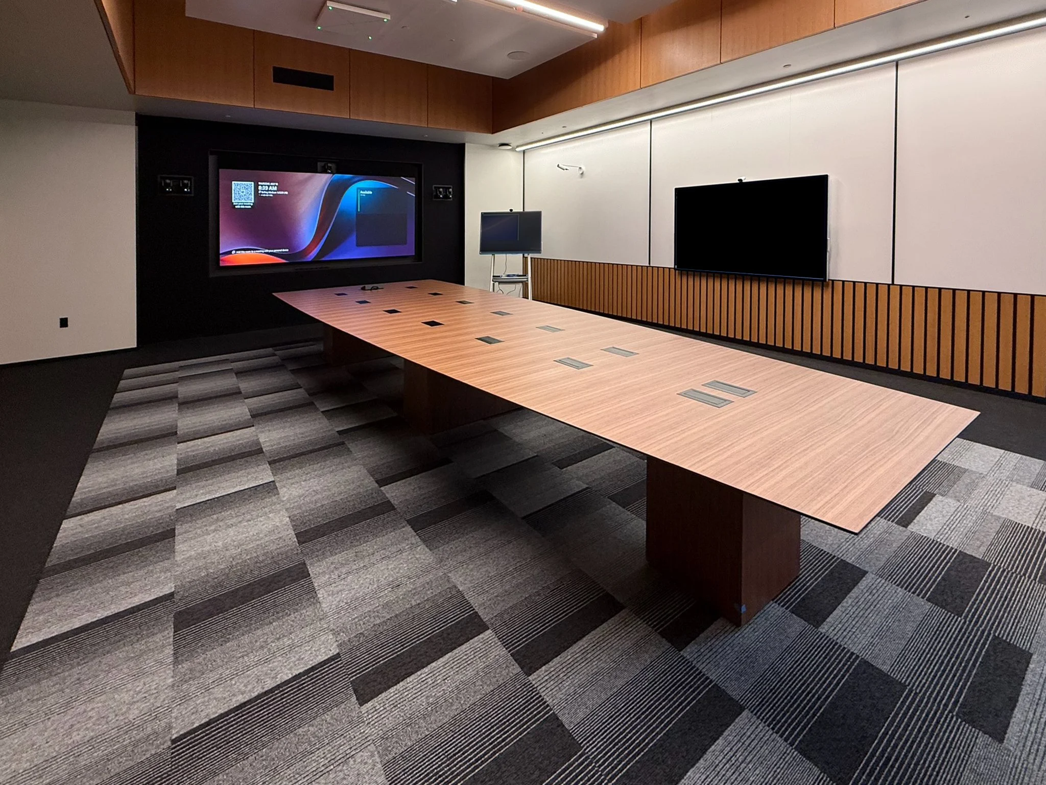 WALNUT VENEER CUSTOM SHAPED CONFERENCE TABLE TOP WITH INSET POWER MODULES AND WALNUT VENEER BOX BASE FOR CONCEALED CORD MANAGEMENT