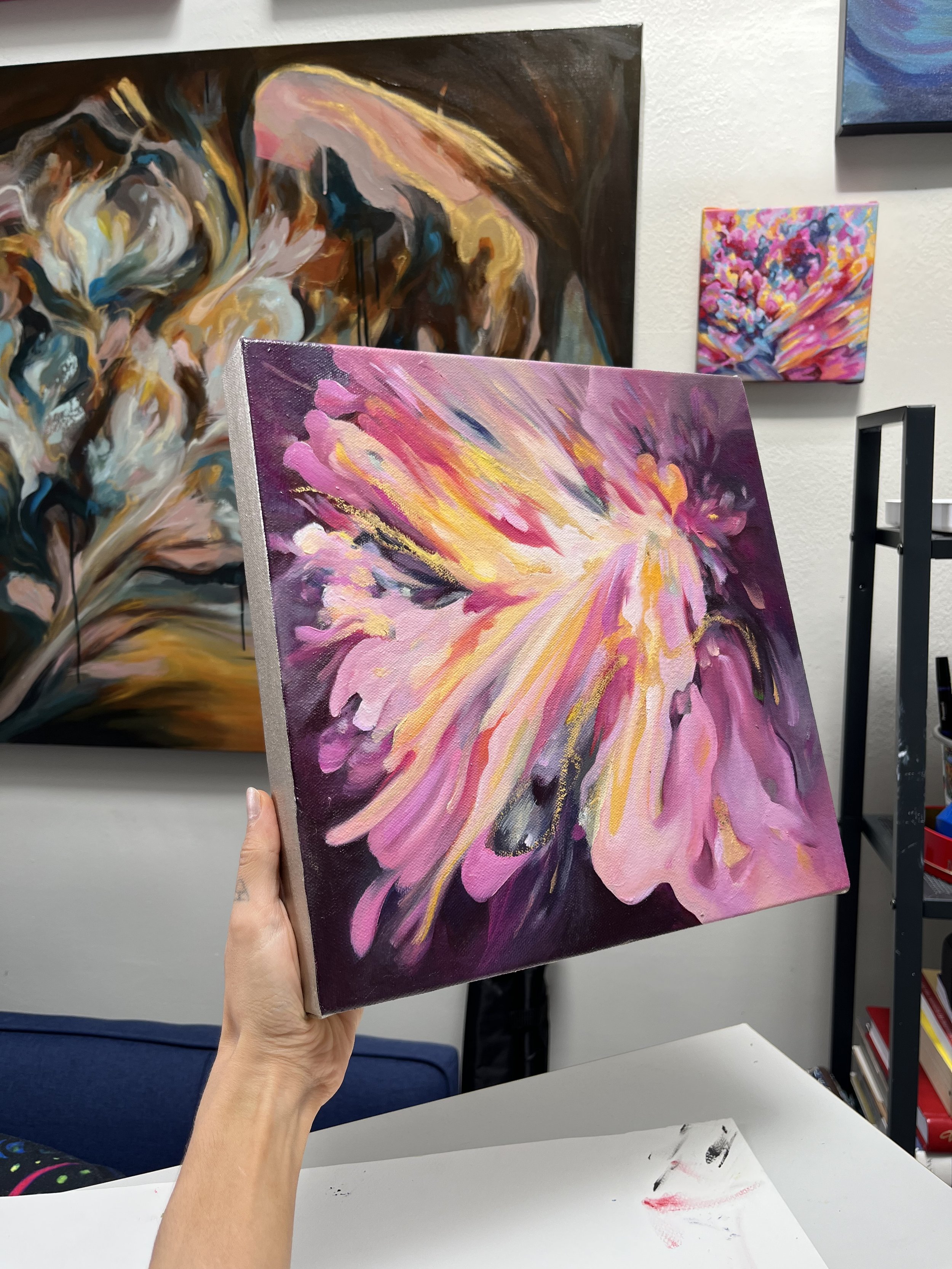 Artist holding Angel Aura painting.jpeg