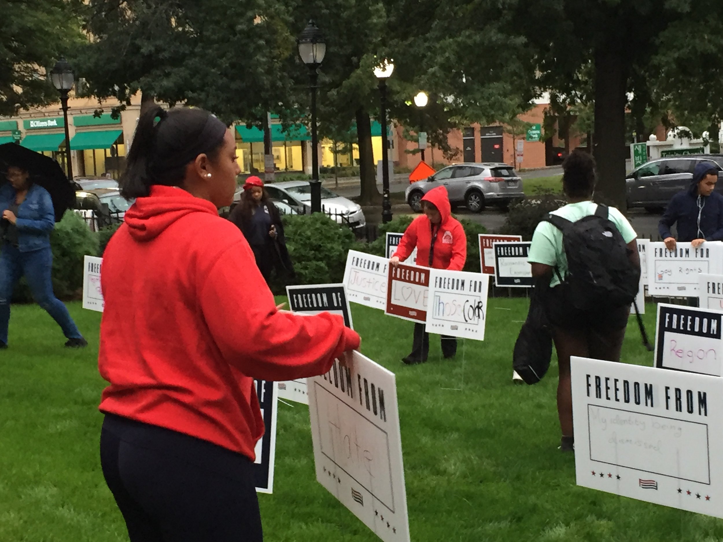 Waltham teens install the For Freedoms lawn signs in front of the library. LITT supplies the signs for Waltham and other partner libraries that take part.