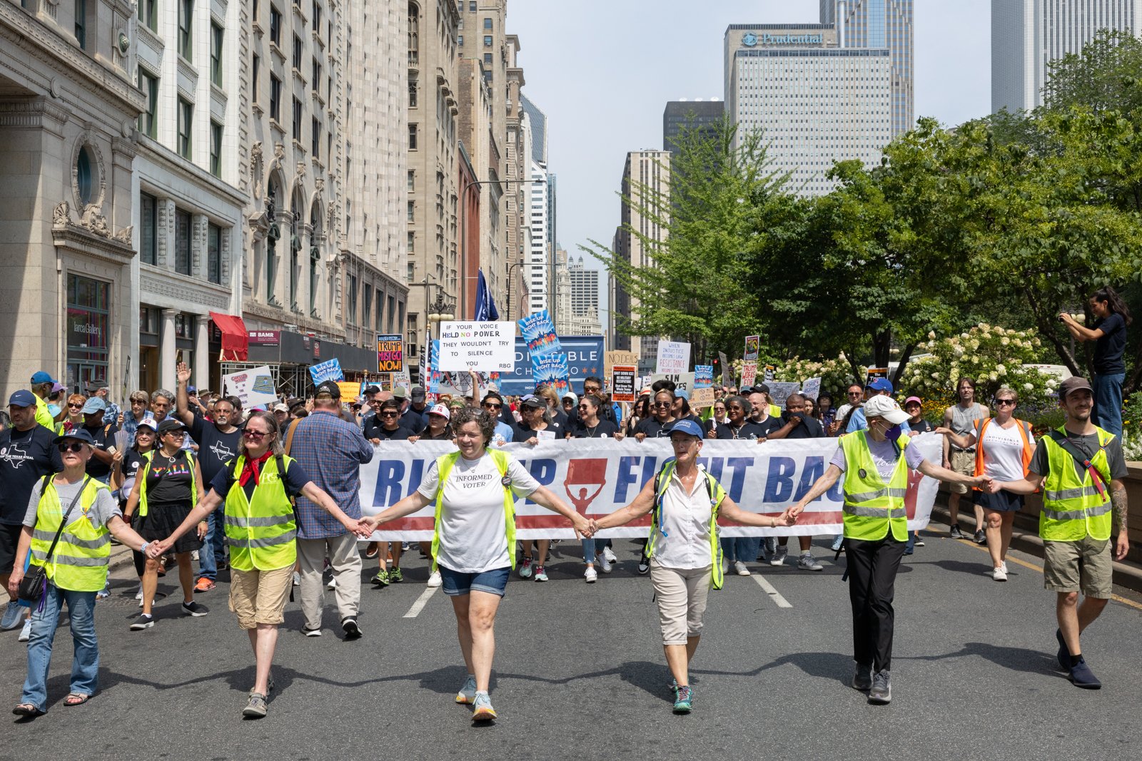 Indivisible Chicago safety marshals lead a march in downtown Chicago