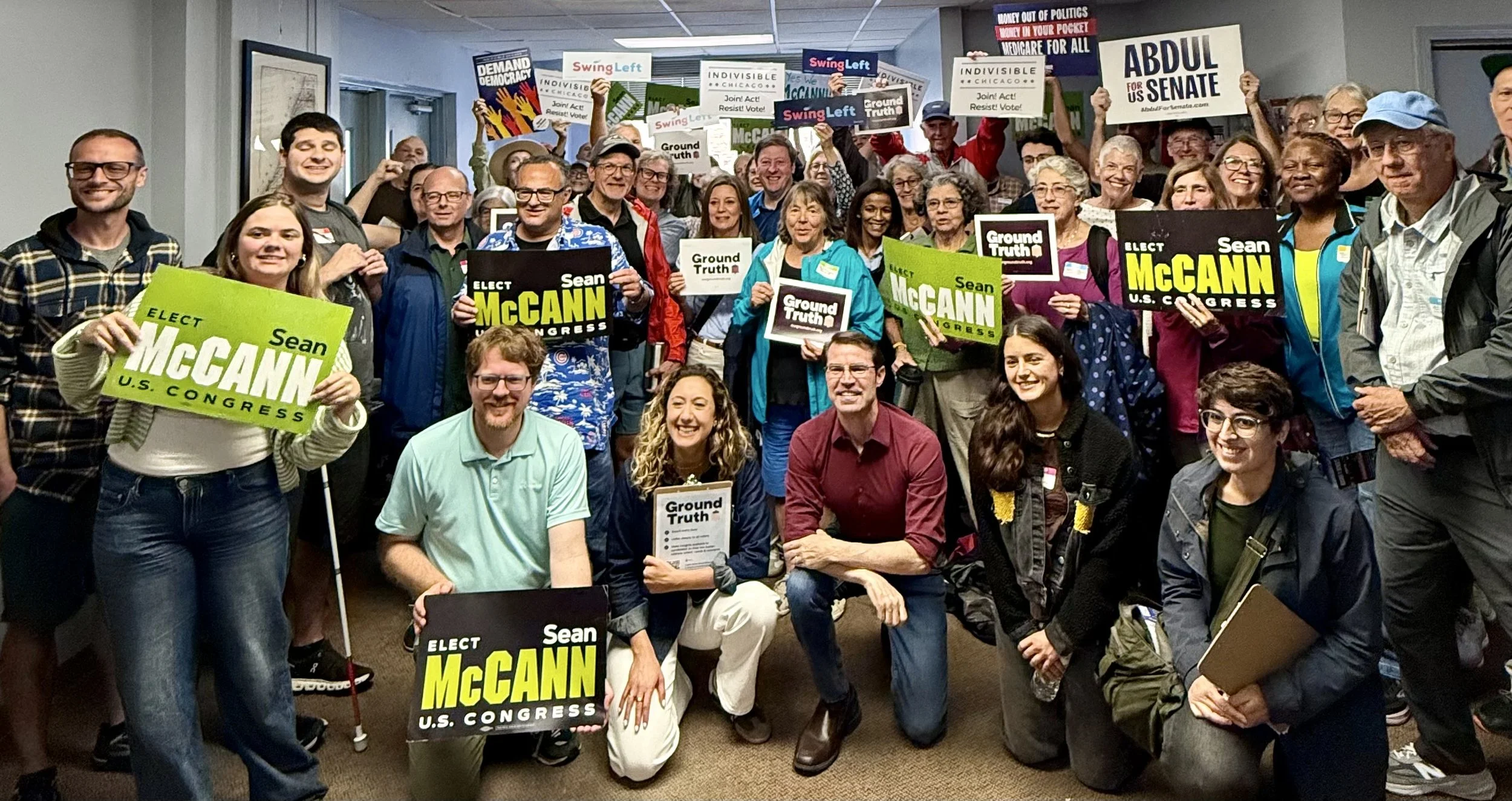 Indivisible Chicago and Swing Left Ground Truth canvassers gather for a group photo in Benton Harbor, Michigan on August 30, 2026. Volunteers hold signs for Sean McCann for US House and Abdul El-Sayed for US Senate