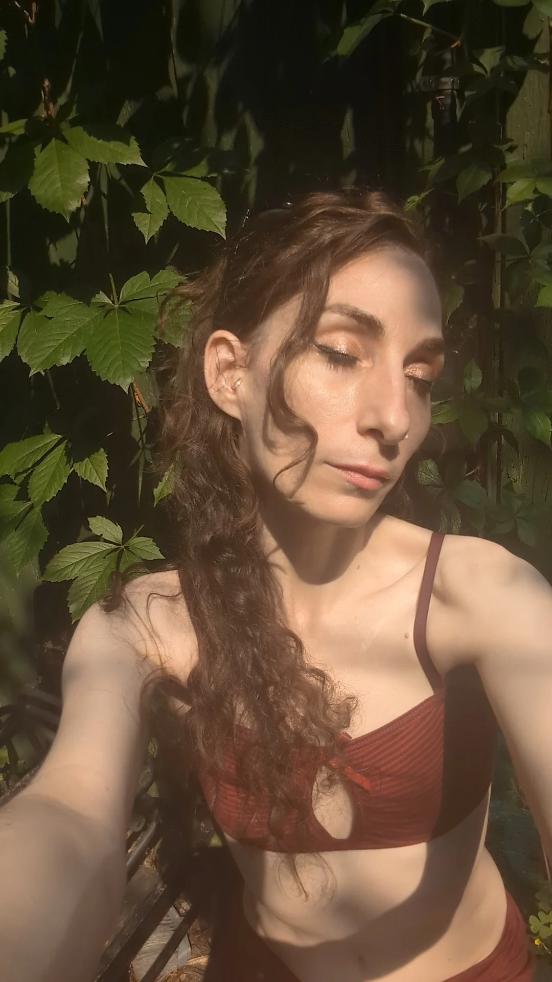 Woman sun vine outside eyes closed long hair