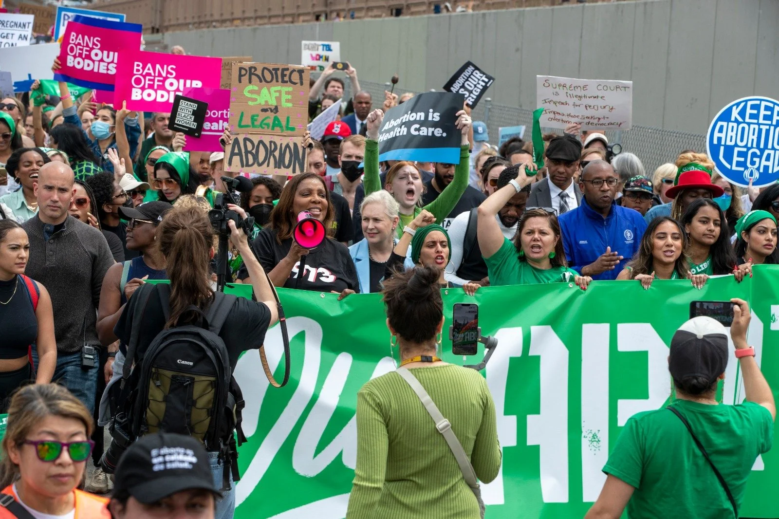 AG James at the front of the march, surrounded by fellow marchers with signs