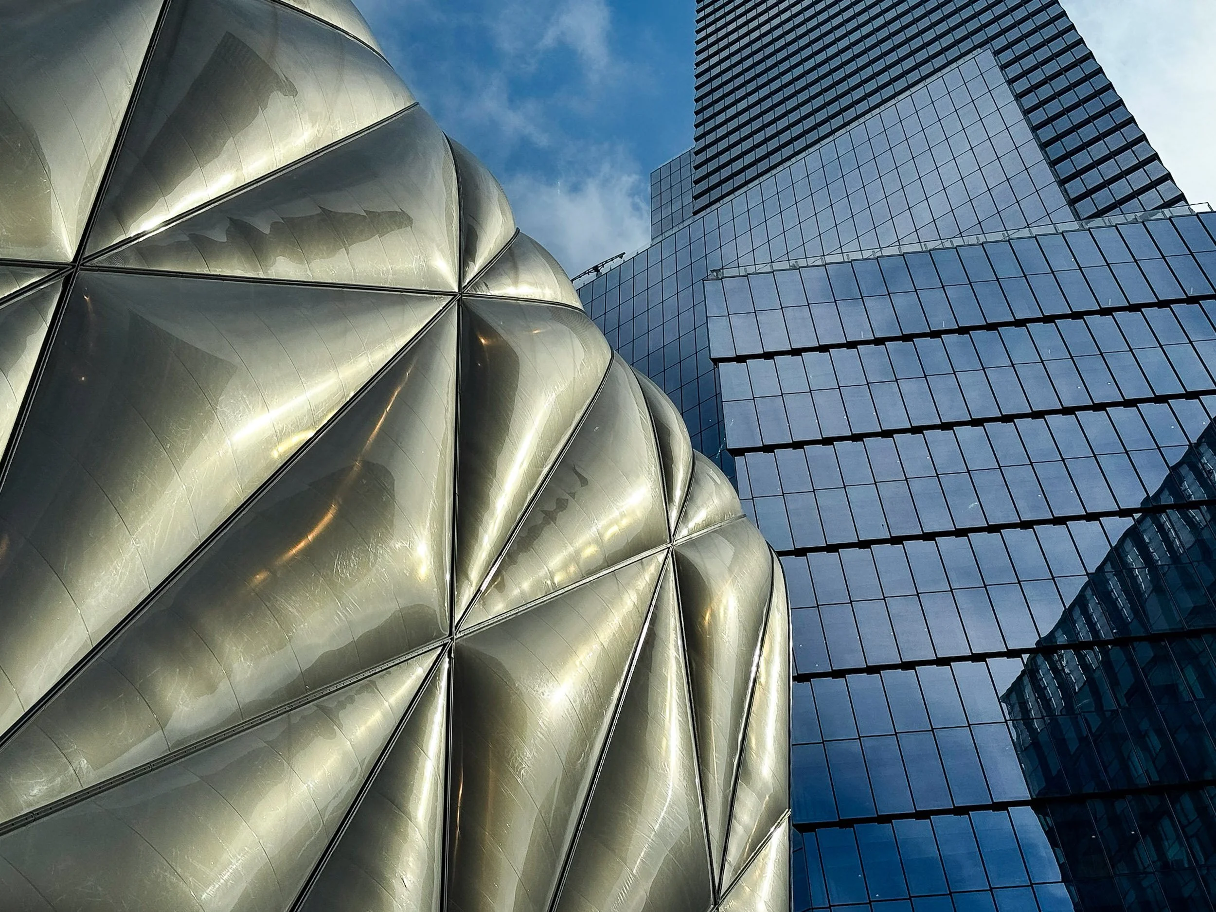 The Shed and High-Rise Textures - A fascinating contrast of modern building materials, showing the movable quilted outer shell of The Shed against sleek glass skyscrapers.
