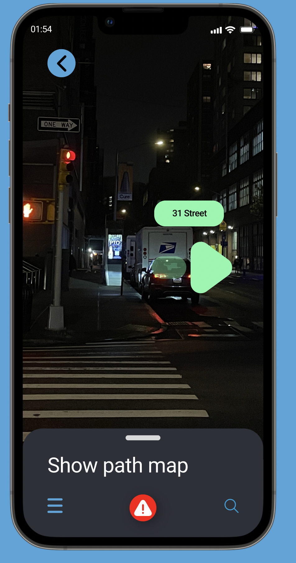 Nighttime city street scene with a crosswalk, a traffic light showing red, parked cars including a USPS mail truck, and buildings with illuminated windows.