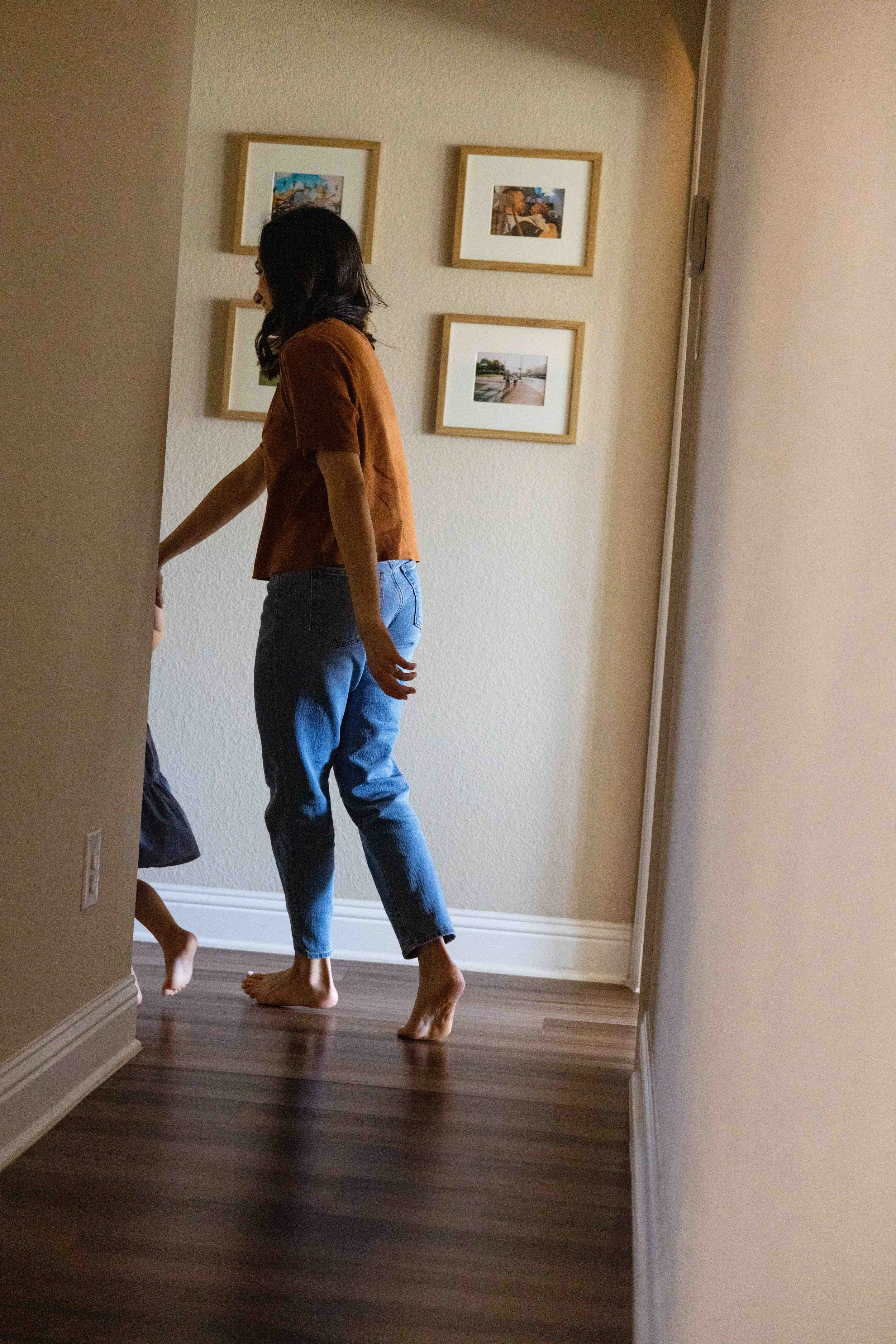 Mother daughter running through hallway