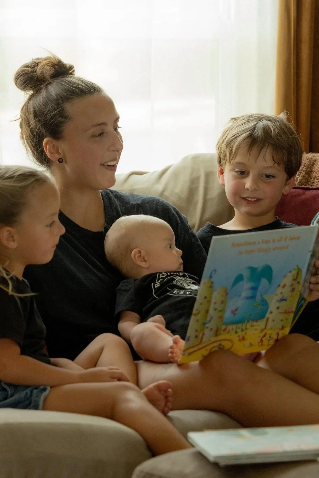 Mom reading to her three kids