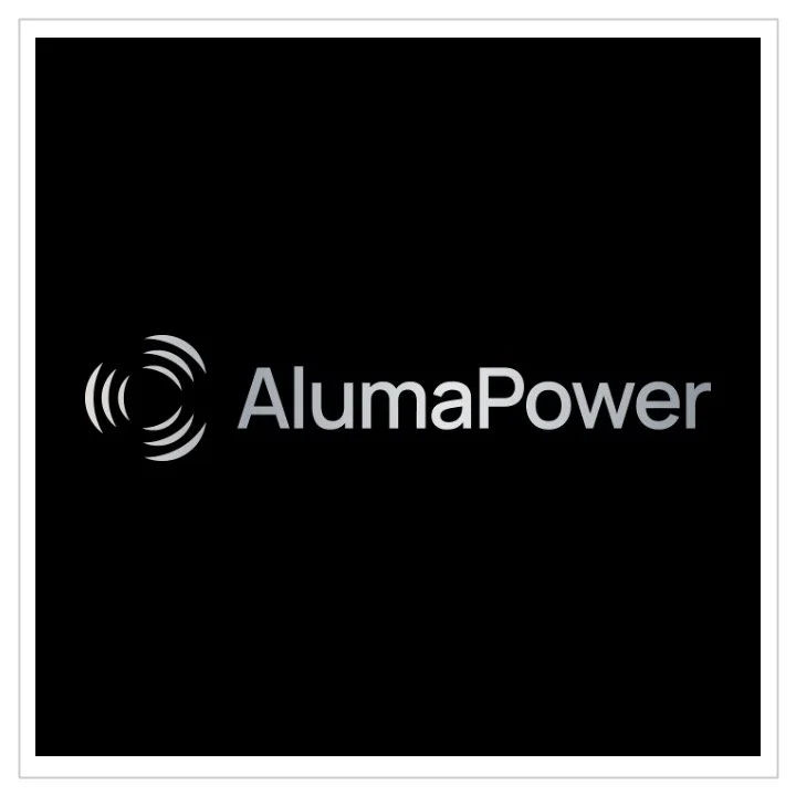 The Alumapower logo displayed on a black background. It includes a circular symbol with radiating lines and the text 'AlumaPower' in gray.