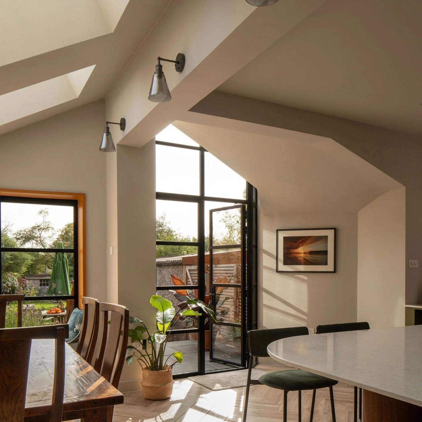 2/3 - The form of the extension in plan and elevation creates a sculpted internal space, with large picture window and full height cranked glazed screen. These frame the external garden and adjoining terrace while providing additional daylight and na