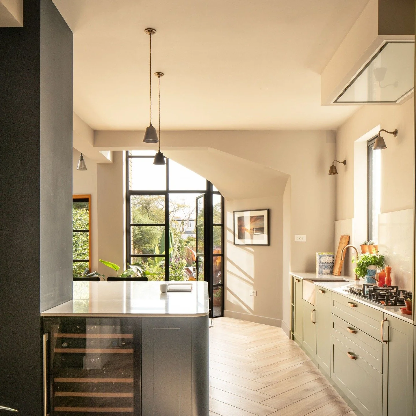 3/3 - At Kent House Road bold and complementary colours are used internally with a bronze coloured sink set into the olive green kitchen units. A herringbone timber floor runs through the ground floor linking the old and new parts of the house. 

A C