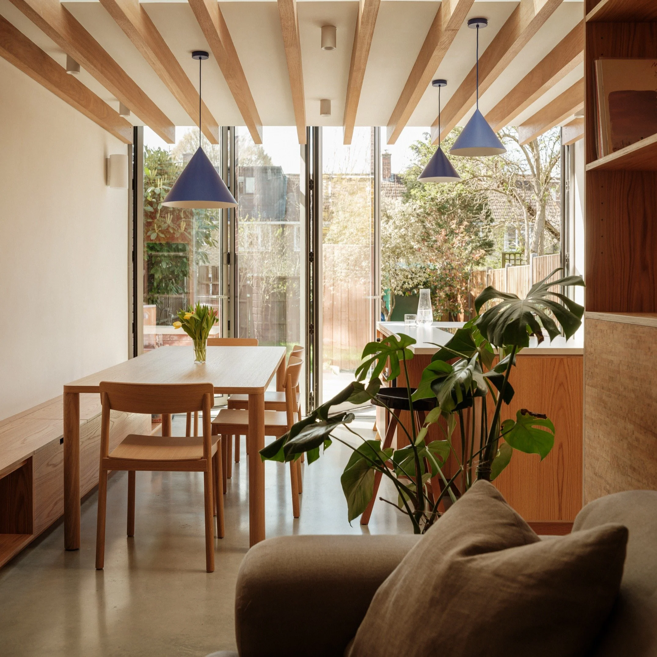 4/4 - Our Dulwich House interior concept is influenced by a rich mid-century architectural material palette comprising exposed Iroko beams, exposed plywood, polished concrete, limewash painted walls, against rich and contrasting coloured joinery. 

T