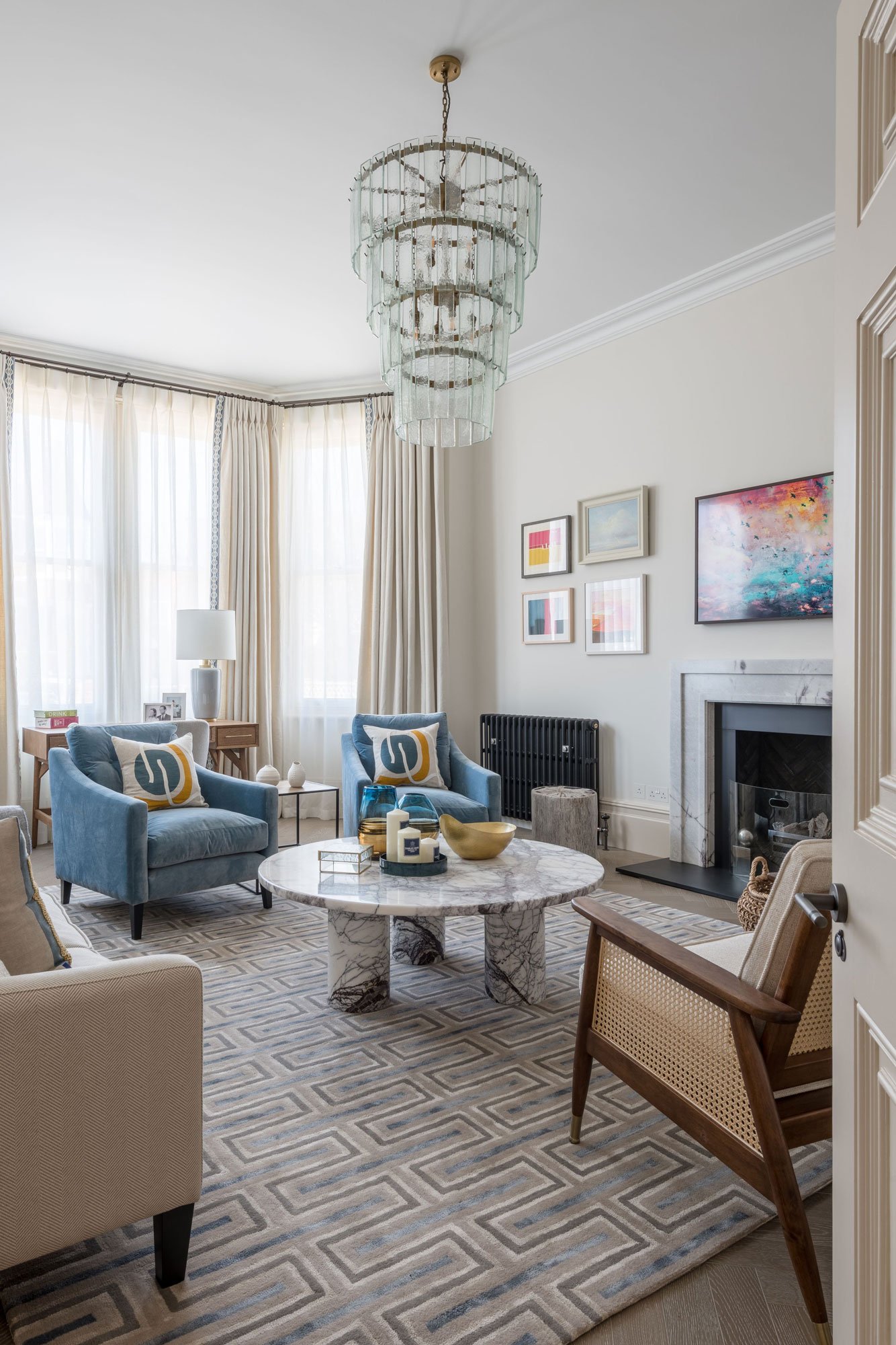 Living area with chairs, marble effect table and chandelier - Marjoram Architects Kings Road Project