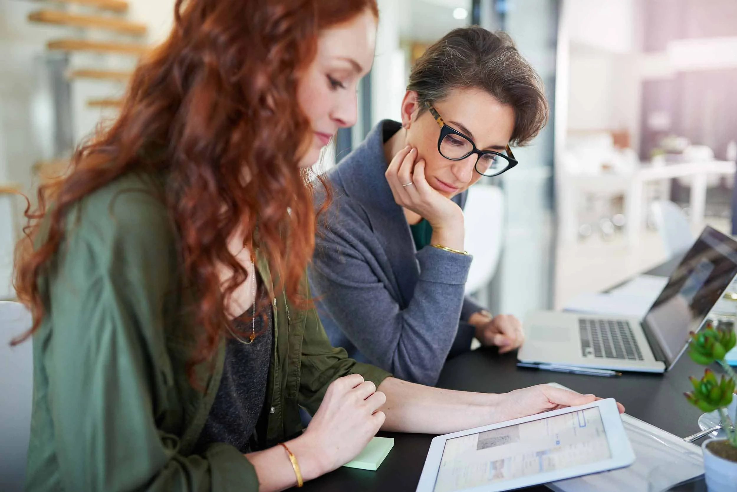 two women discussing results on ipad