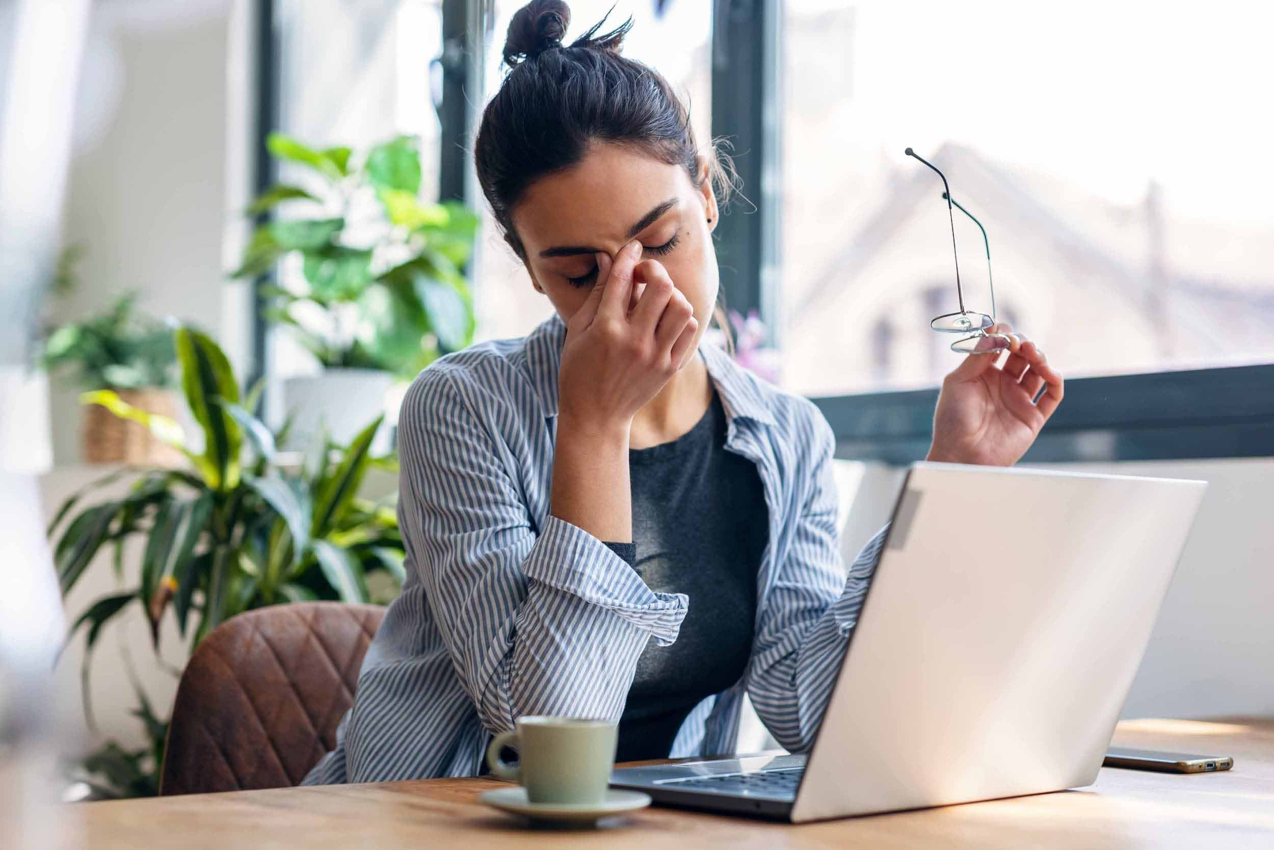 woman tired pinching nose